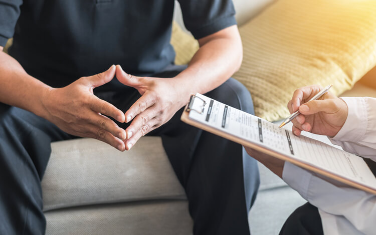 patient filling out a form with their doctor