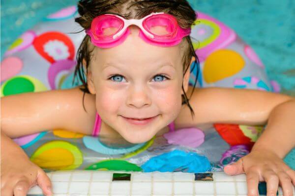 child looking up from inside a swimming pool