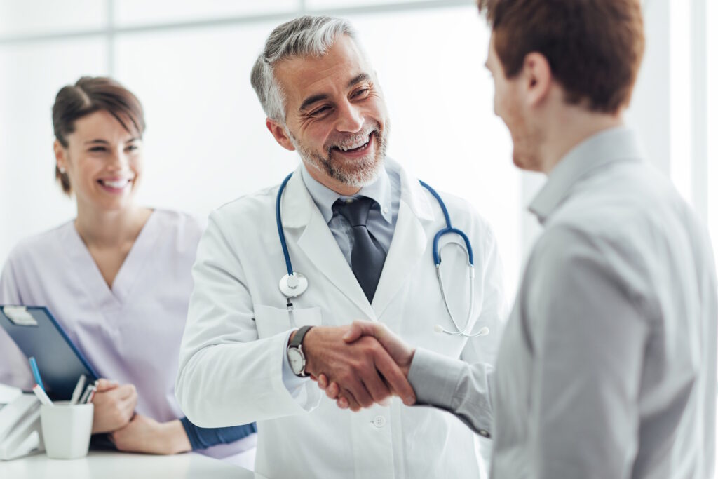 medical practitioners smiling and shaking hands